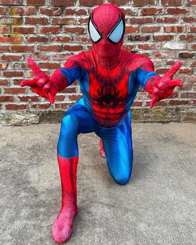 person in spider man costume, crouching
