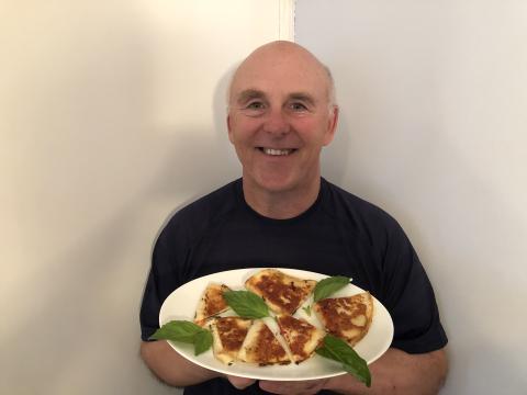 chef rob holding plate of quesadillas