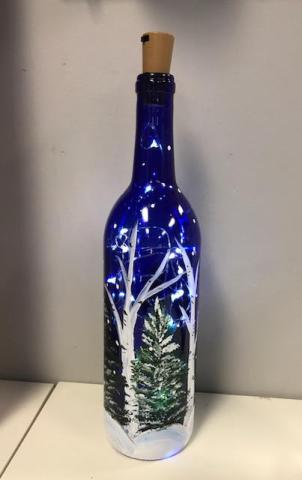 Upcycled painted glass bottles lit with fairy lights